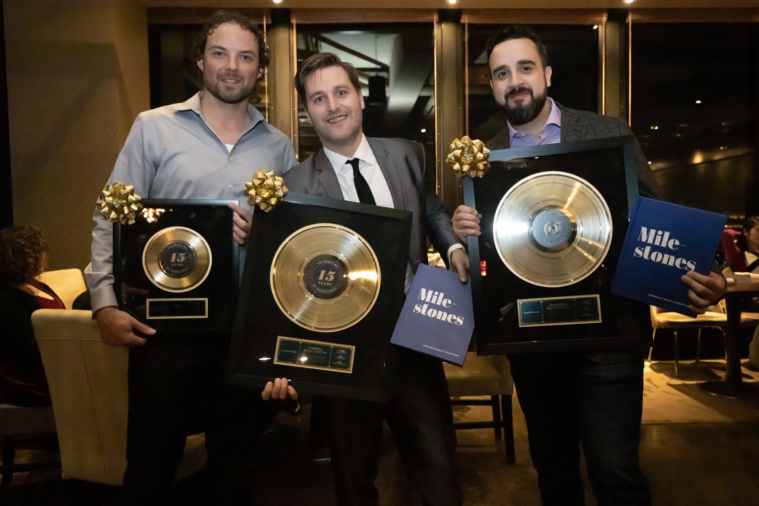 Chris Book, Darryl Ballantyne and Mohamed Moutadayne holding awards